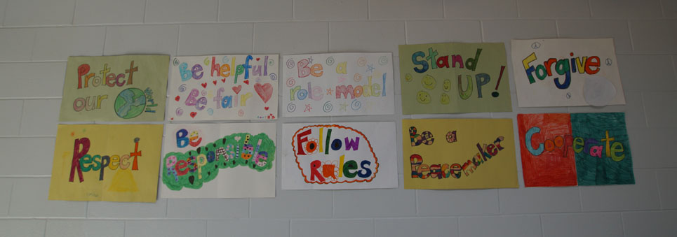 Artwork on a wall promoting respect, kindness, helping others, code of conduct